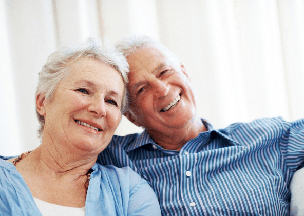 A smiling couple reviewing their Medicare options